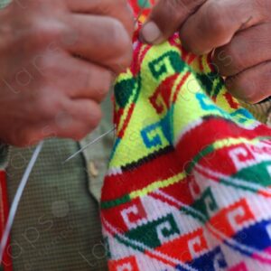Detail hands man weaving colorful traditional hat 2