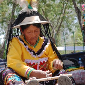 Indigenous old woman weaves with a foot loom 3