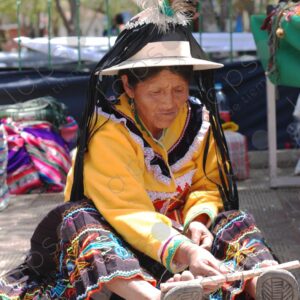 Indigenous old woman weaves with a foot loom 4