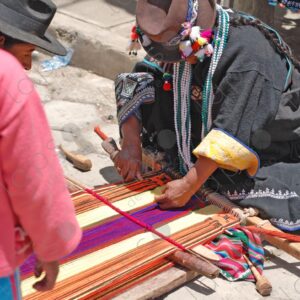 Indigenous woman working on loom