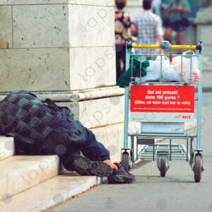 Homeless person sleeps with an airport trolley 3