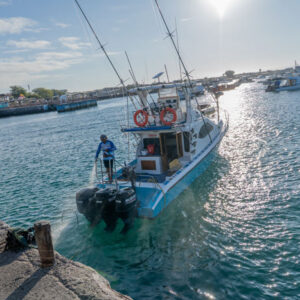 cleaning a boat at sunset san cristobal island galapagos