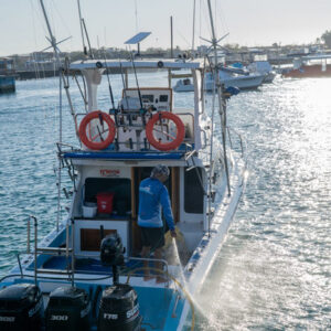 cleaning a boat on san cristobal island galapagos