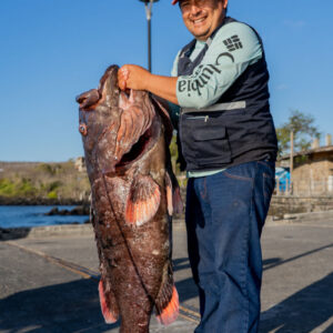 man poses with fish 2