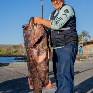 man poses with fish 3