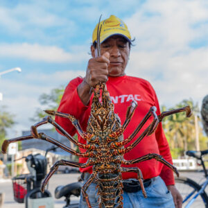man poses with lobster 3
