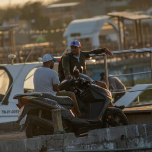 men talking on pier