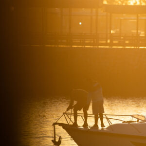 people at harbor with anchor in backlight 4