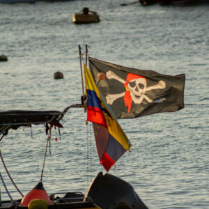 pirate and ecuadorian flags on boat san cristobal island galapagos