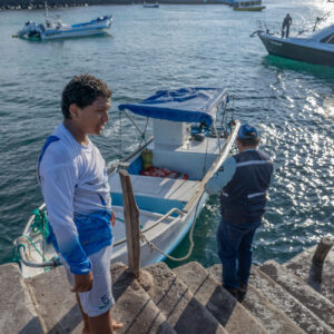 young people on pier receiving catch 1