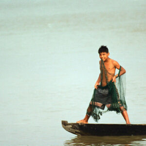 young man prepares the net for fishing